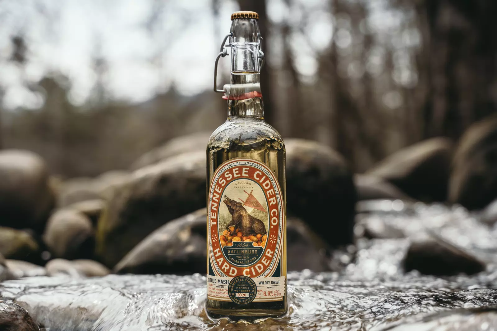 Tennessee Cider Co bottle on river rocks